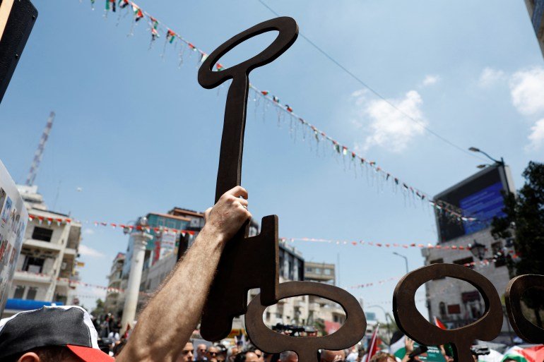 Palestinians hold a key during a commemoration of the Nakba