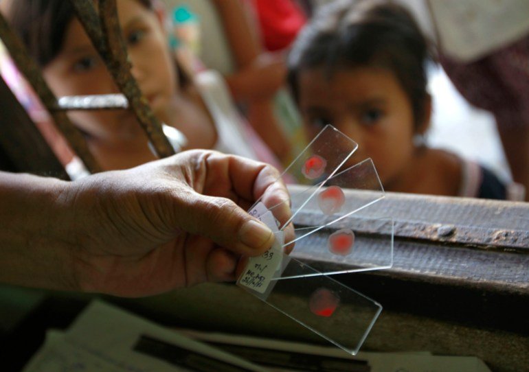 A Ministry of Public Health official holds blood test slides taken from children, who live in the Thai-Myanmar border, at a malaria clinic in the Sai Yoke district, Kanchanaburi Province October 26, 2012. Globally, 3.3 billion people are at risk of malaria infection. While Africa has the highest malaria burden, most the 46,000 deaths outside Africa occurred in Asia Pacific. There are also concerns over a growing parasite resistance. Studies and research show artemisinin-based therapies - currently the most effective treatment against malaria - are taking longer to cure some of the patients. REUTERS/Sukree Sukplang (THAILAND - Tags: POLITICS HEALTH DISASTER)