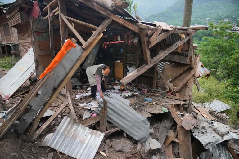A person inspects his damaged shop following overnight shelling from Pakistan at Gingal village in Uri district, Indian controlled Kashmir, Friday, May 9, 2025.